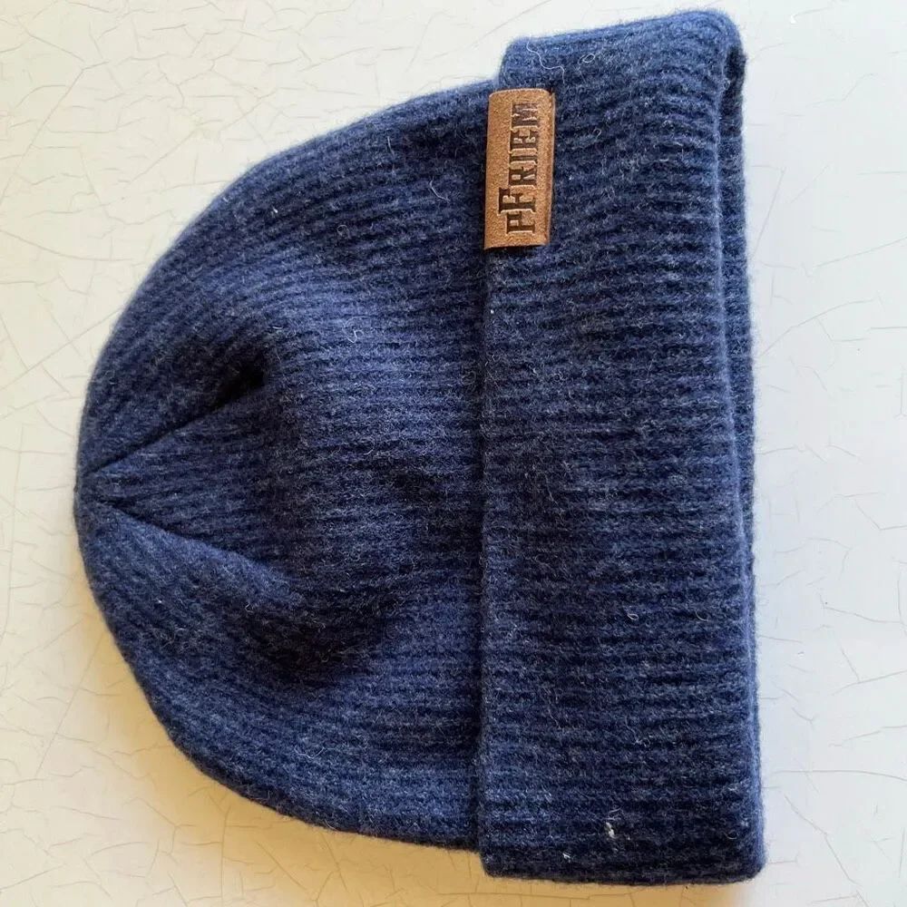 pFriem Blue Merino Wool Beanie, featuring a dark blue ribbed knit design with a